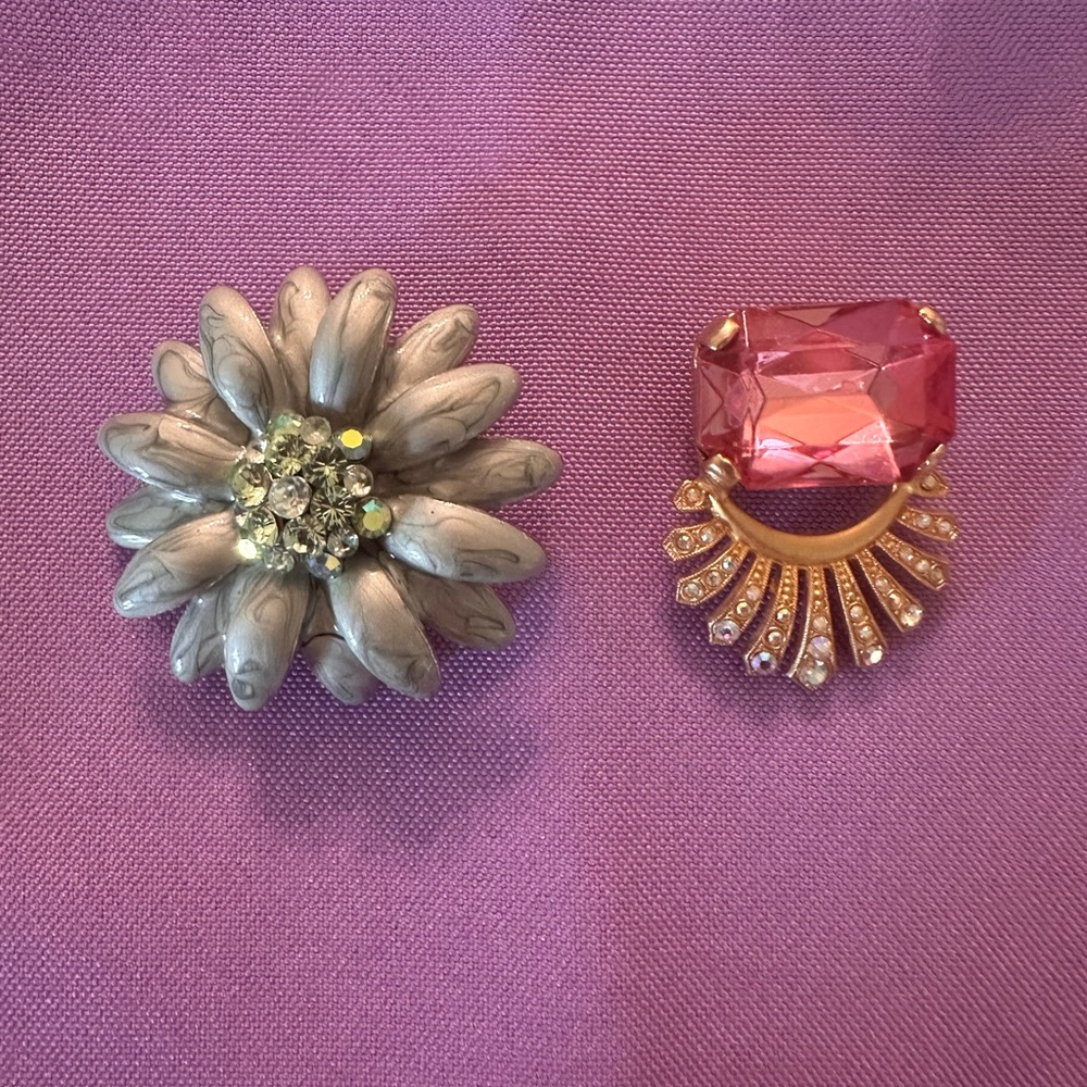Enamel green flower pin with rhinestones and a pink and gold brooch